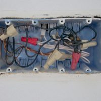 Detailed view of an opened electrical switchboard with visible wires and connectors.