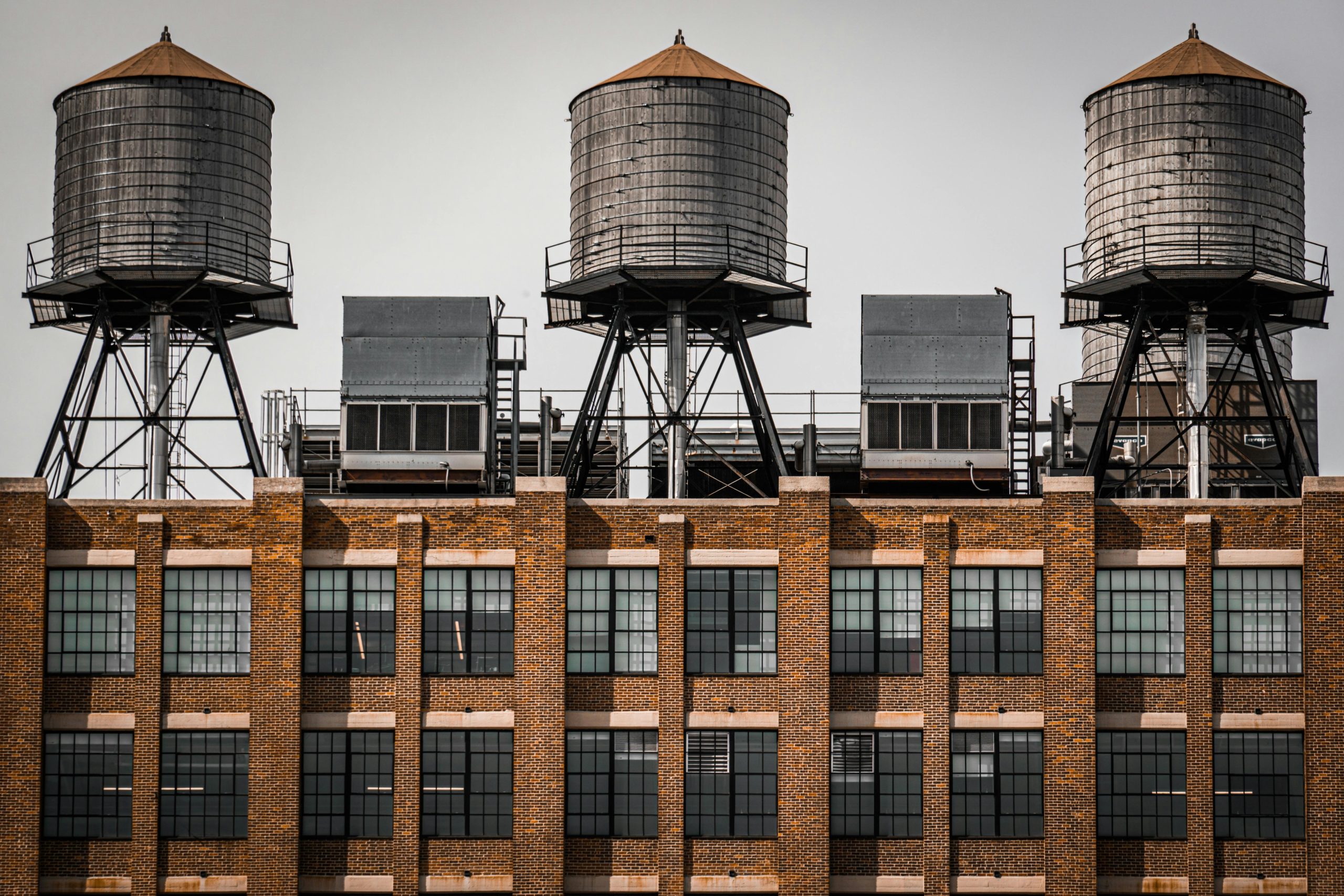 Iconic water towers on a New York City rooftop, showcasing urban architecture.