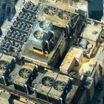 High-angle shot of HVAC units on a city building's rooftop, showcasing industrial infrastructure.