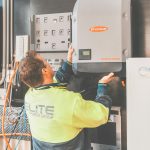 Expert technician setting up a solar inverter in Thornton, NSW, ensuring efficient solar energy flow.