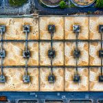 An aerial photo of a large industrial treatment plant in Indonesia, showcasing structured symmetry.