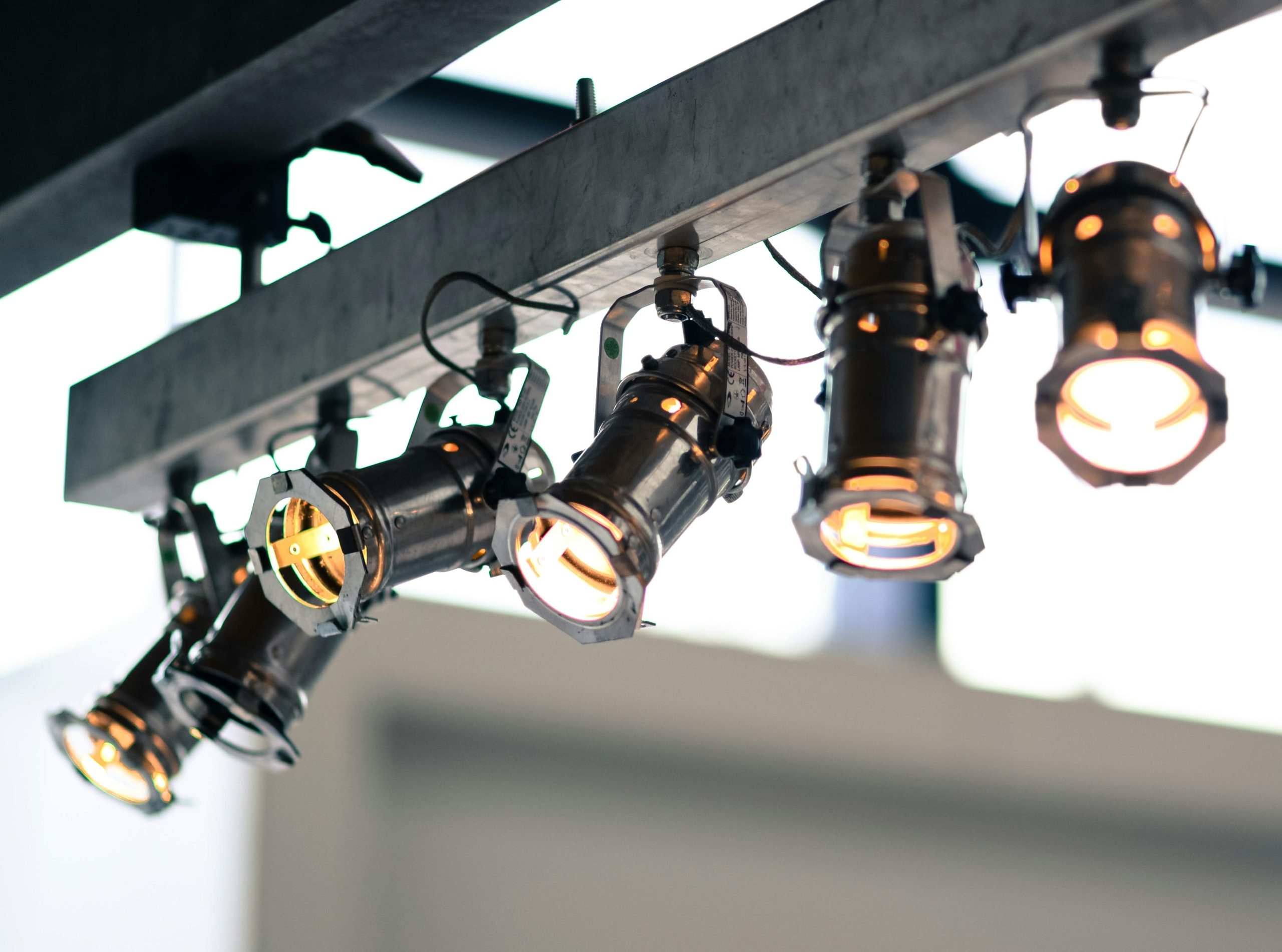 Modern industrial spotlights mounted on a ceiling providing focused illumination.